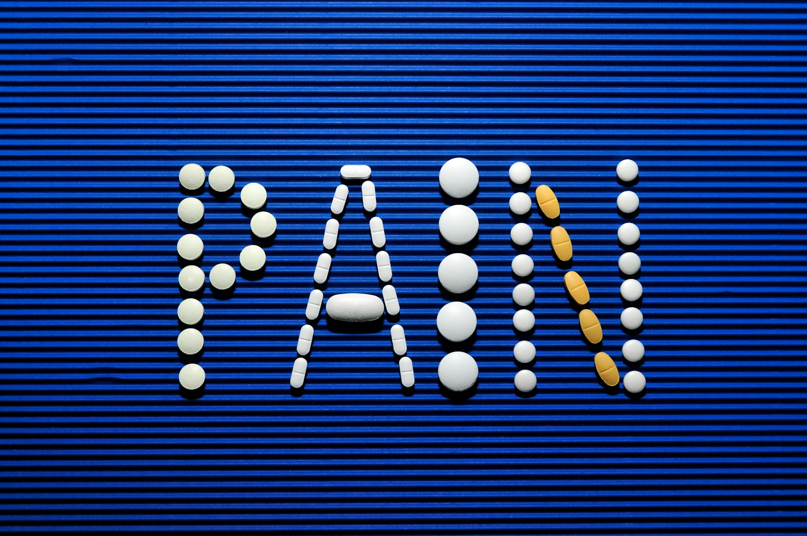 The word war spelled out of pills on a blue background