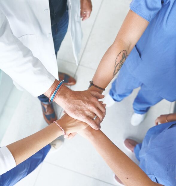 Hands,Together,,Above,And,Meeting,With,Doctors,In,Hospital,For